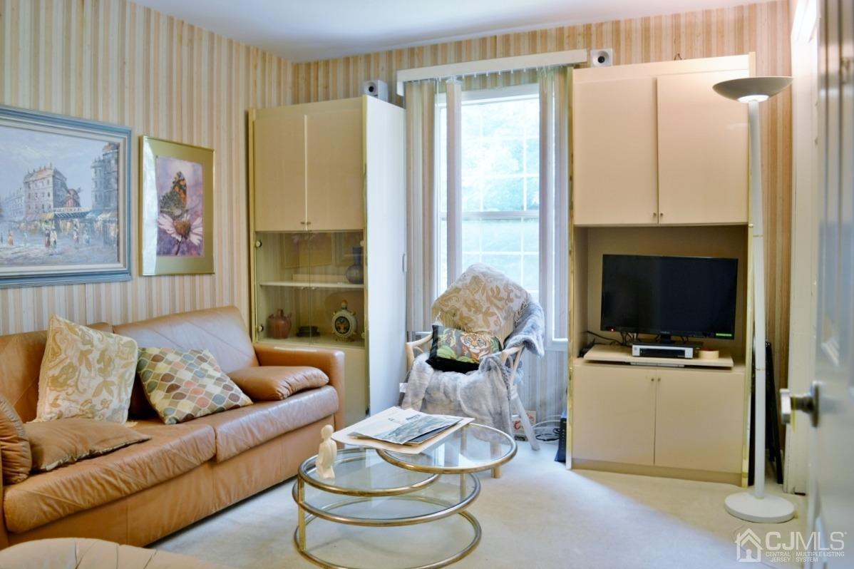 171 Concordia Circle, Unit C Monroe Township, NJ 08831 - Photo 8 of 13 a living room with furniture and a flat screen tv