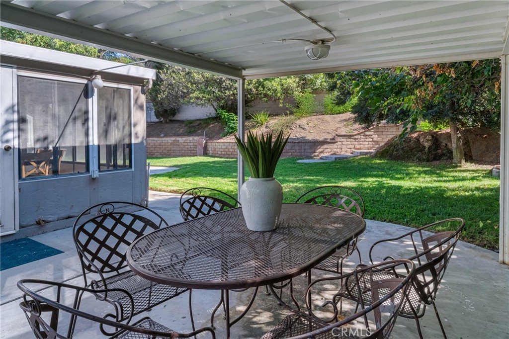 5165 Pearblossom Drive Riverside, CA 92507 - Photo 13 of 75 a view of a patio with a table chairs and a backyard
