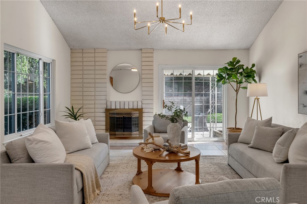 5165 Pearblossom Drive Riverside, CA 92507 - Photo 2 of 75 a living room with furniture a fireplace and a potted plant