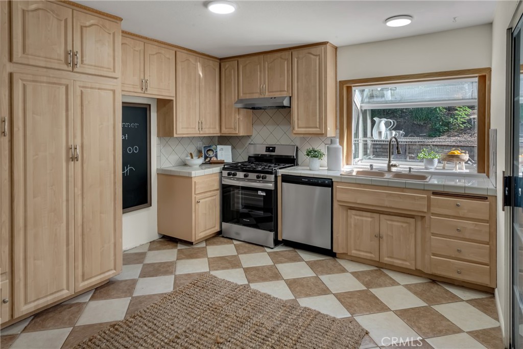 5165 Pearblossom Drive Riverside, CA 92507 - Photo 22 of 75 a kitchen with a stove a sink and a window