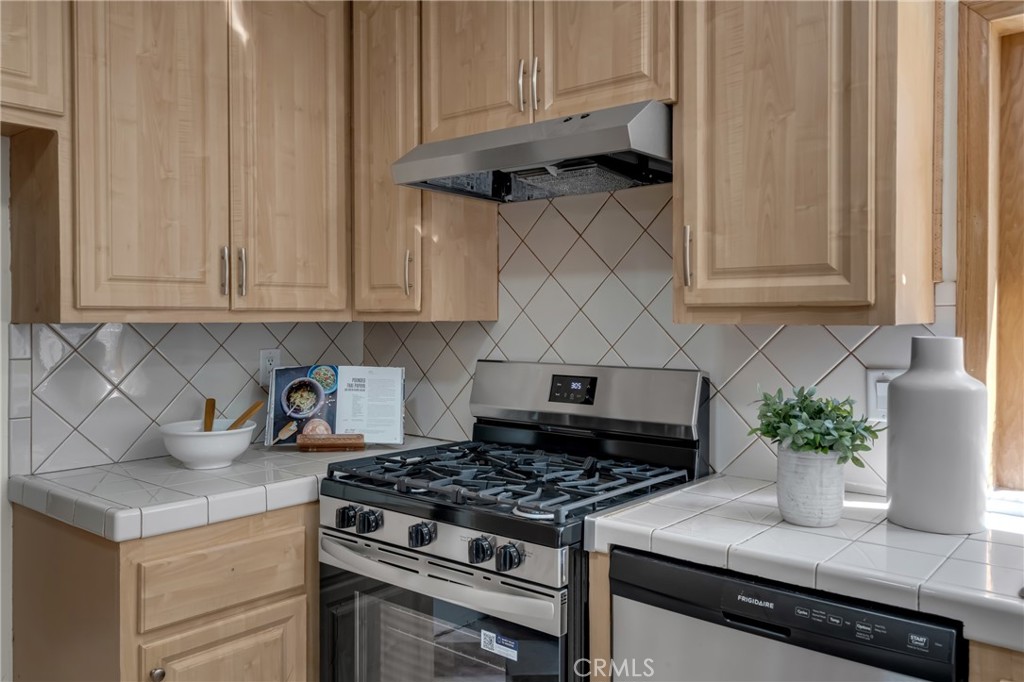 5165 Pearblossom Drive Riverside, CA 92507 - Photo 24 of 75 a kitchen with granite countertop white cabinets and stainless steel appliances