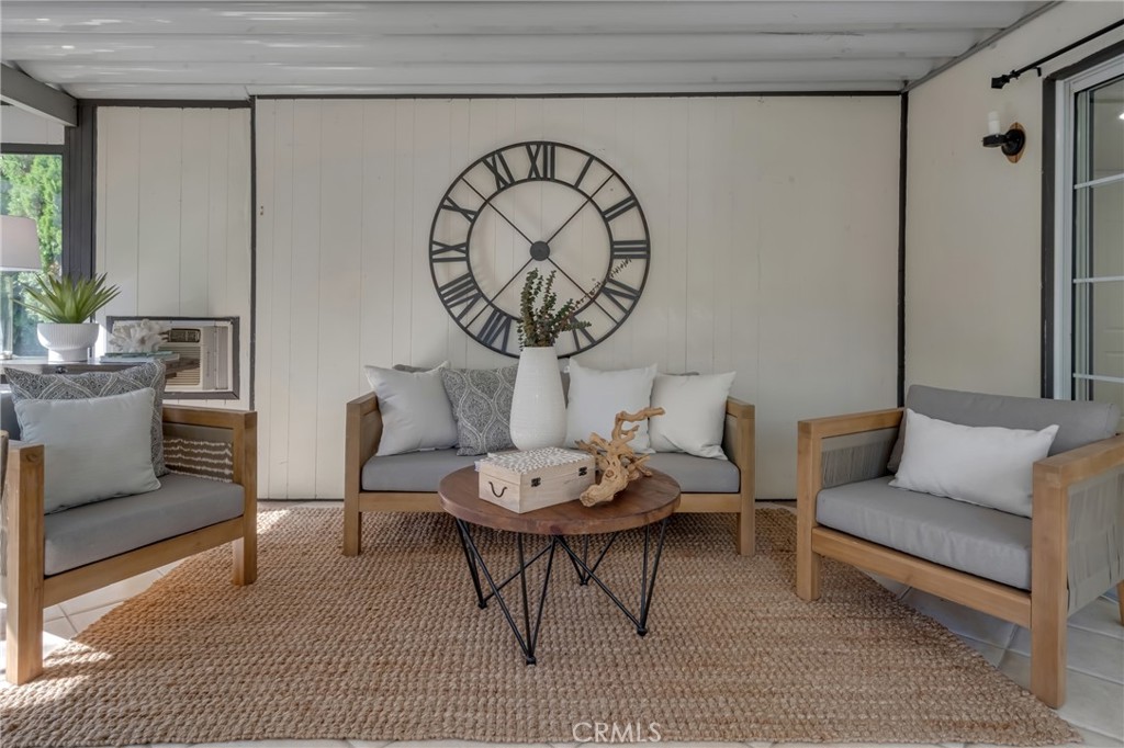 5165 Pearblossom Drive Riverside, CA 92507 - Photo 27 of 75 a living room with furniture a rug and a wall painting