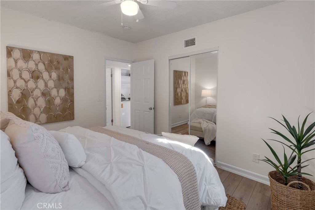 5165 Pearblossom Drive Riverside, CA 92507 - Photo 38 of 75 a bedroom with a large bed and a potted plant