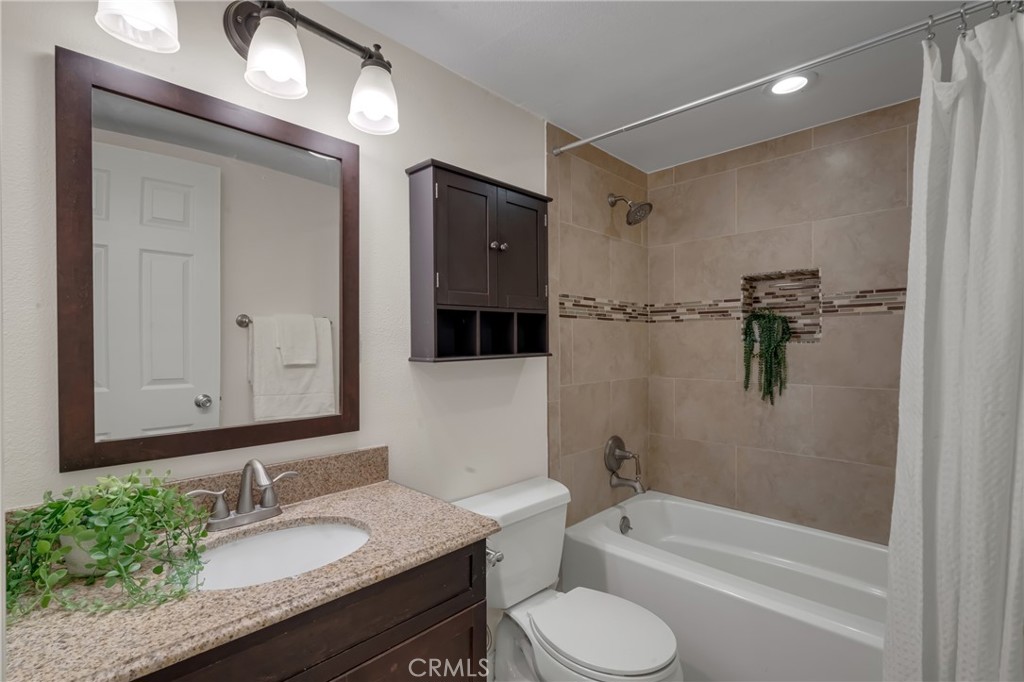 5165 Pearblossom Drive Riverside, CA 92507 - Photo 39 of 75 a bathroom with a granite countertop sink toilet and shower