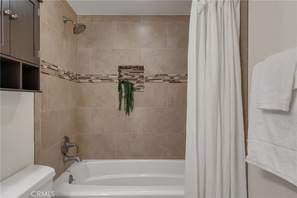 5165 Pearblossom Drive Riverside, CA 92507 - Photo 40 of 75 a bathroom with a bathtub and a shower