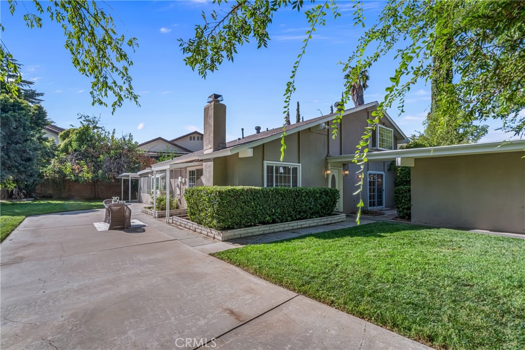 5165 Pearblossom Drive Riverside, CA 92507 - Photo 7 of 75 a front view of a house with a yard and potted plants