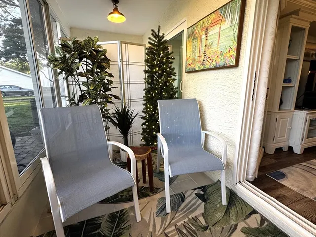 a view of a workspace with furniture and a potted plant
