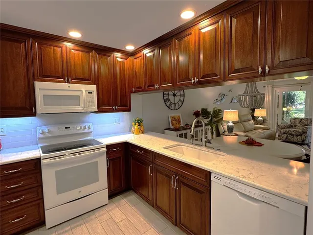a kitchen with appliances cabinets and a sink