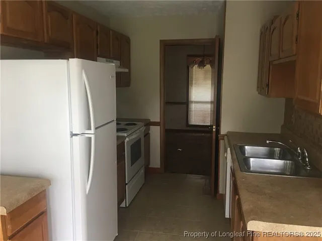 a kitchen with stainless steel appliances a refrigerator and a sink