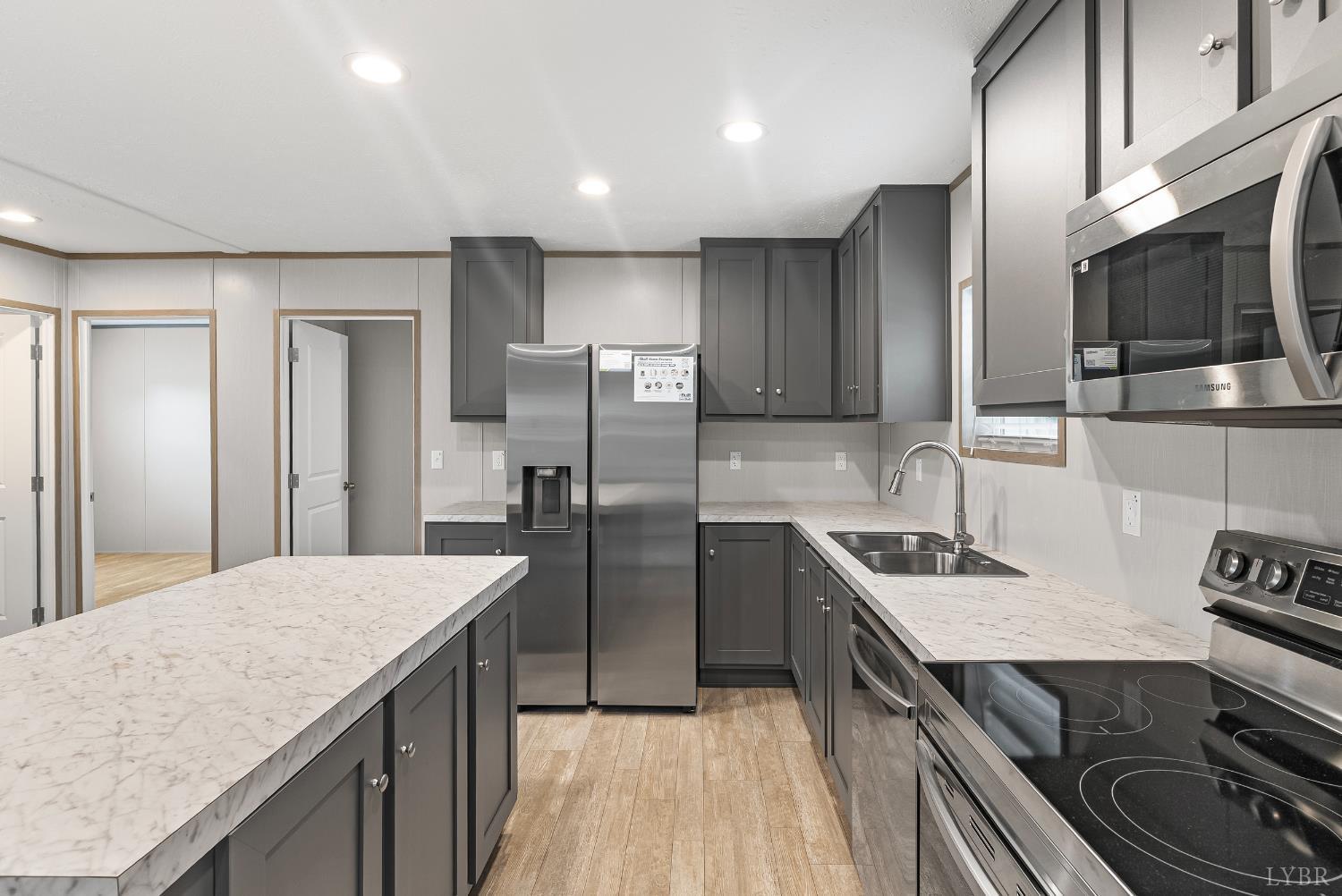 4526 Pigeon Run Road Gladys, VA 24554 - Photo 11 of 54 a kitchen with stainless steel appliances granite countertop a sink stove and refrigerator