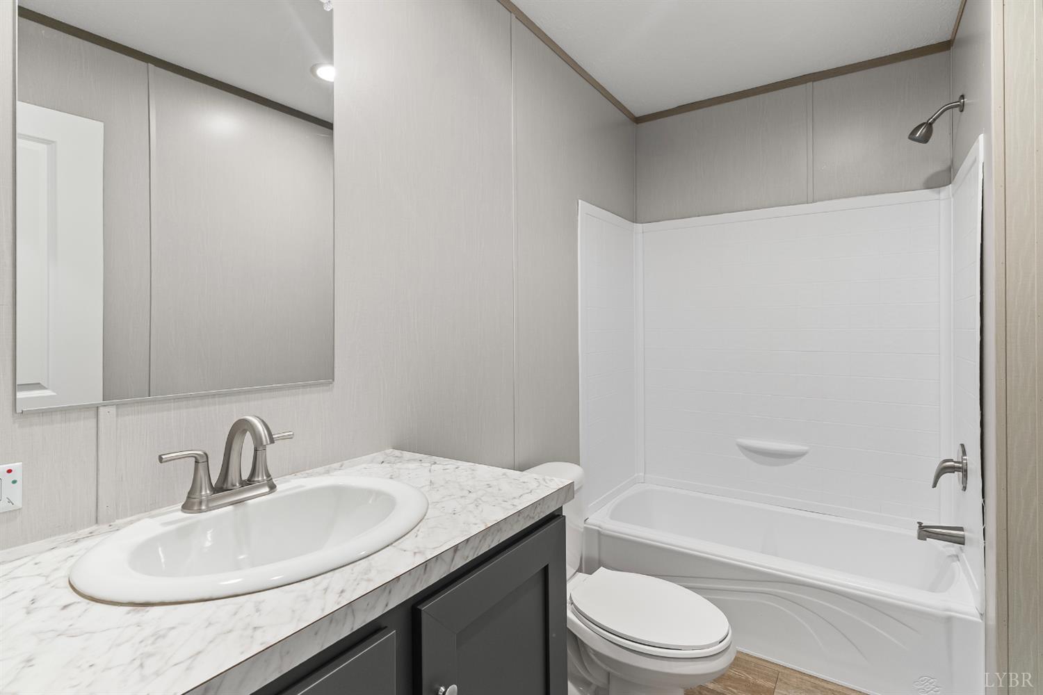 4526 Pigeon Run Road Gladys, VA 24554 - Photo 22 of 54 a bathroom with a granite countertop sink toilet and shower