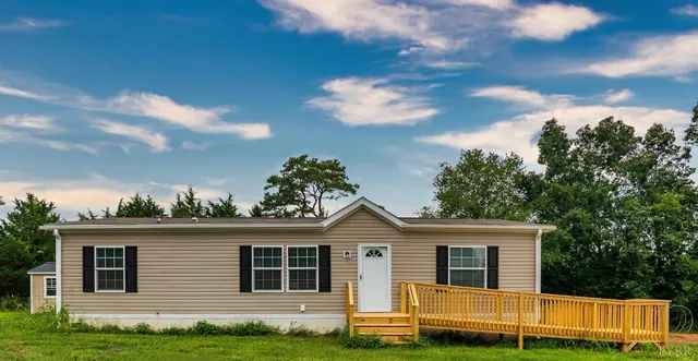 a view of a backyard with large trees