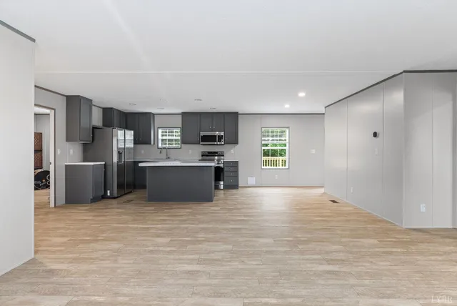 a kitchen with stainless steel appliances a refrigerator and a microwave