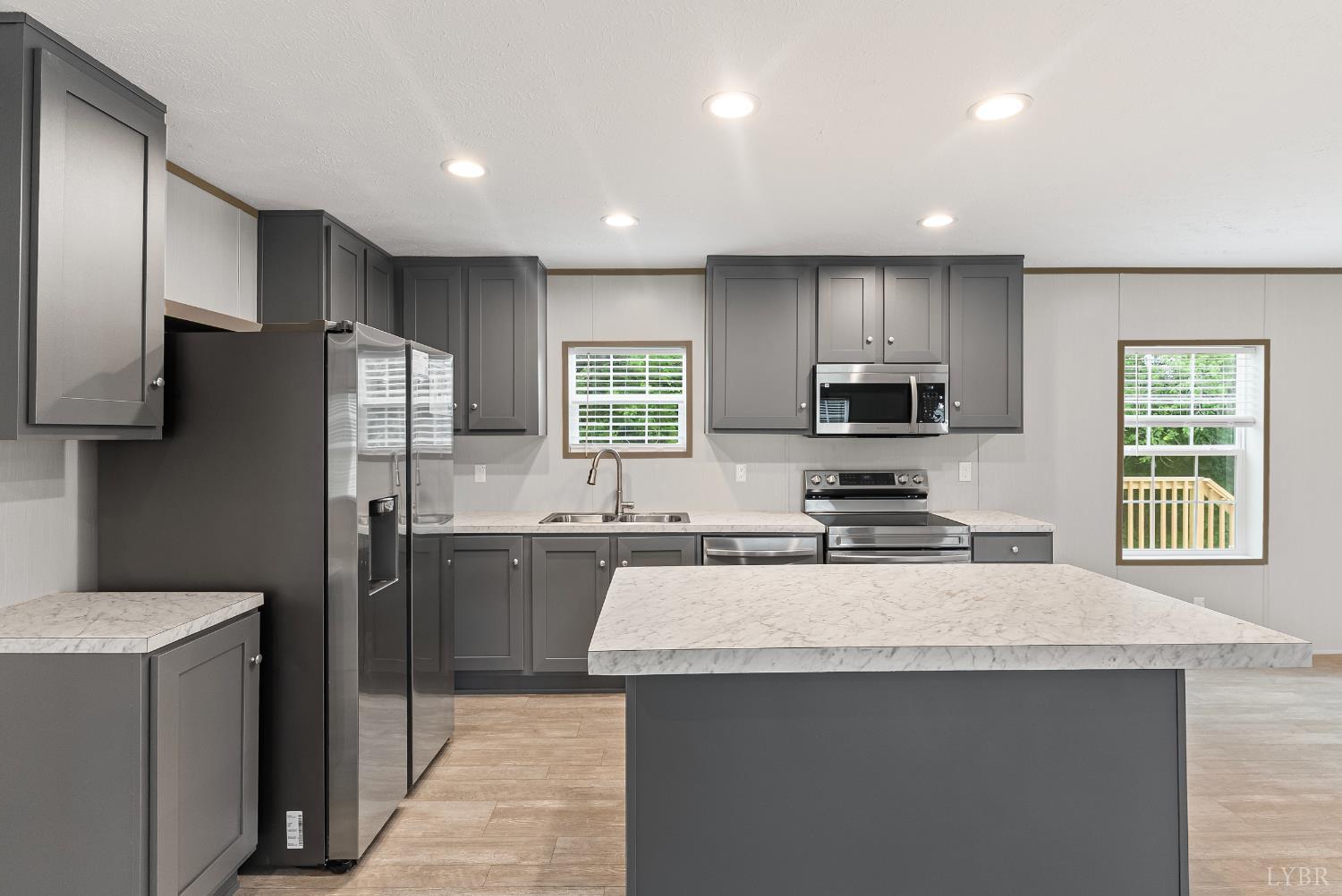 4526 Pigeon Run Road Gladys, VA 24554 - Photo 8 of 54 a kitchen with a refrigerator a sink a stove a microwave and wooden cabinets