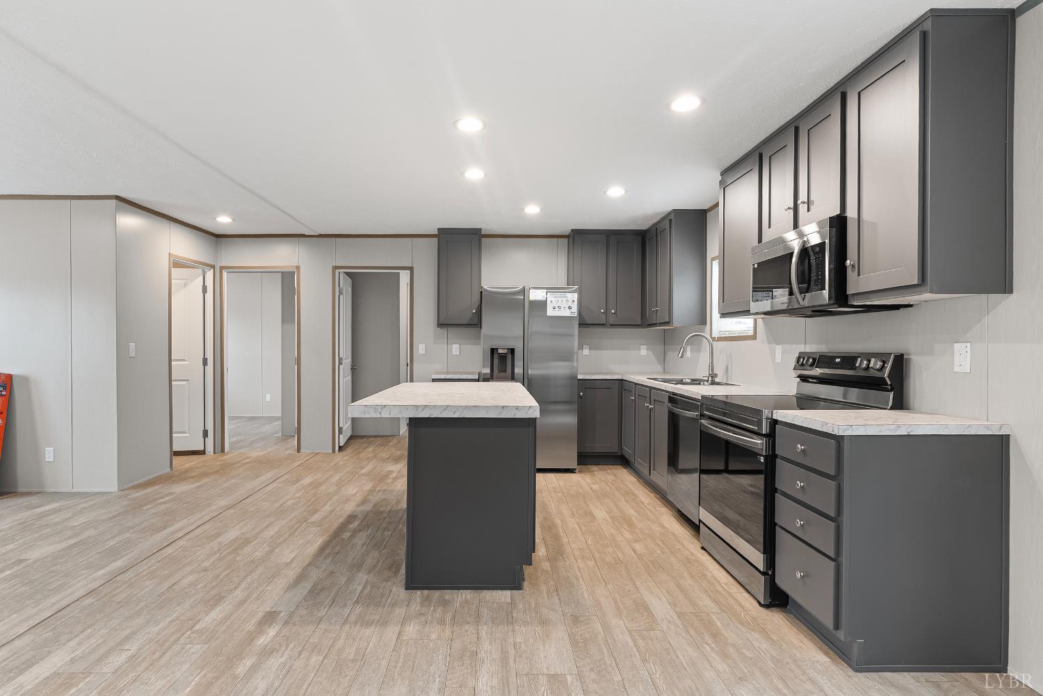 4526 Pigeon Run Road Gladys, VA 24554 - Photo 10 of 54 a kitchen with stainless steel appliances granite countertop a stove a sink dishwasher and a refrigerator with wooden floor