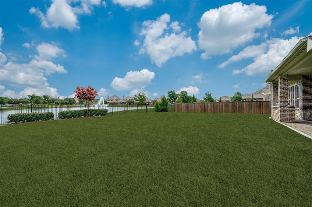 7821 Kentmere The Colony, TX 75056 - Photo 21 of 40 Premium quarter-acre lot offering an expansive backyard with breathtaking views of the neighborhood canal and picturesque water feature. This oversized outdoor retreat provides endless possibilities for a future pool, outdoor entertaining, or simply relaxing while enjoying the peaceful waterfront setting and beautiful open views.