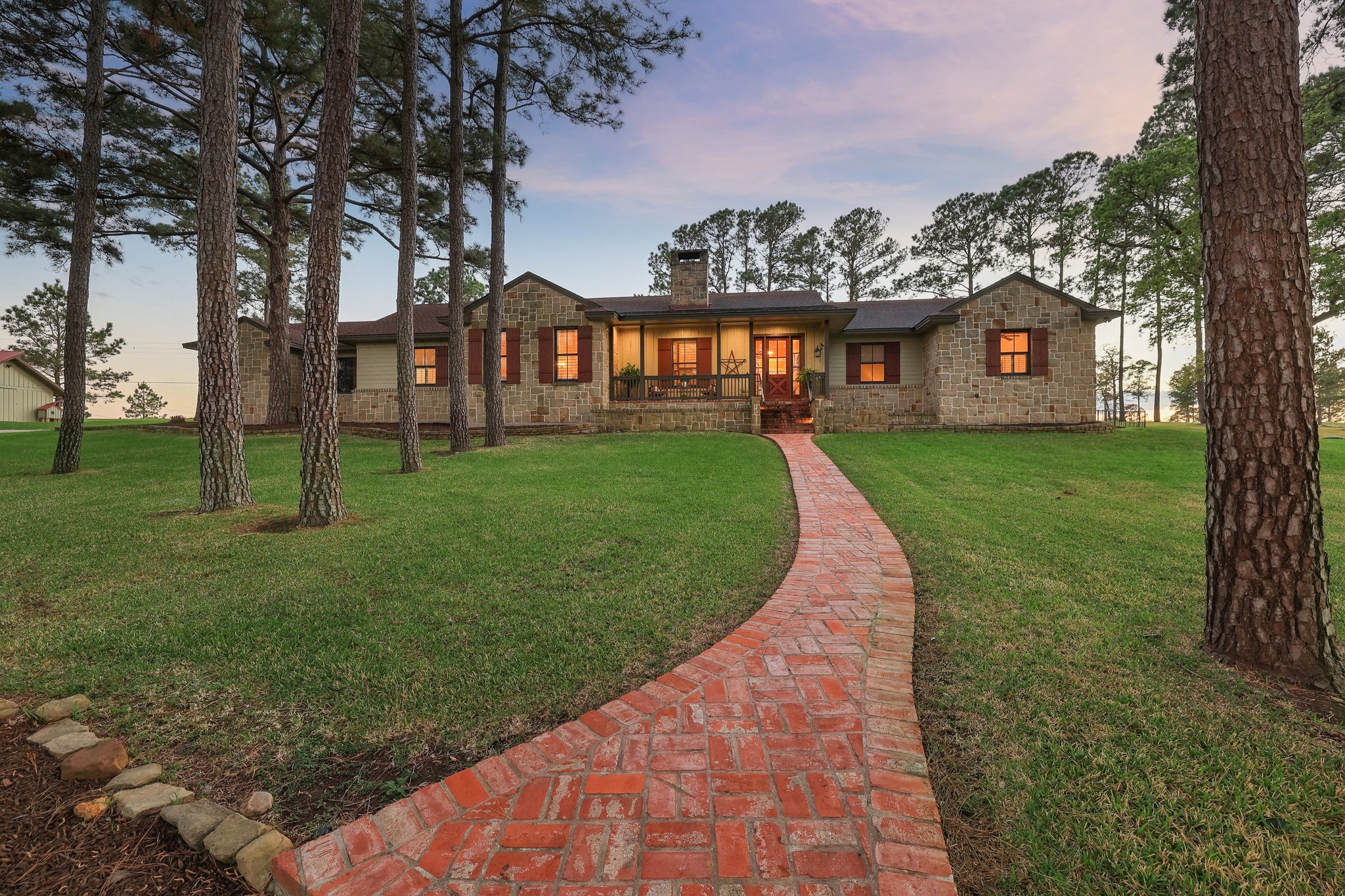 546 McAllister Road Bastrop, TX 78602 - Photo 5 of 40 View of front of house featuring a chimney, a yard, and stone siding