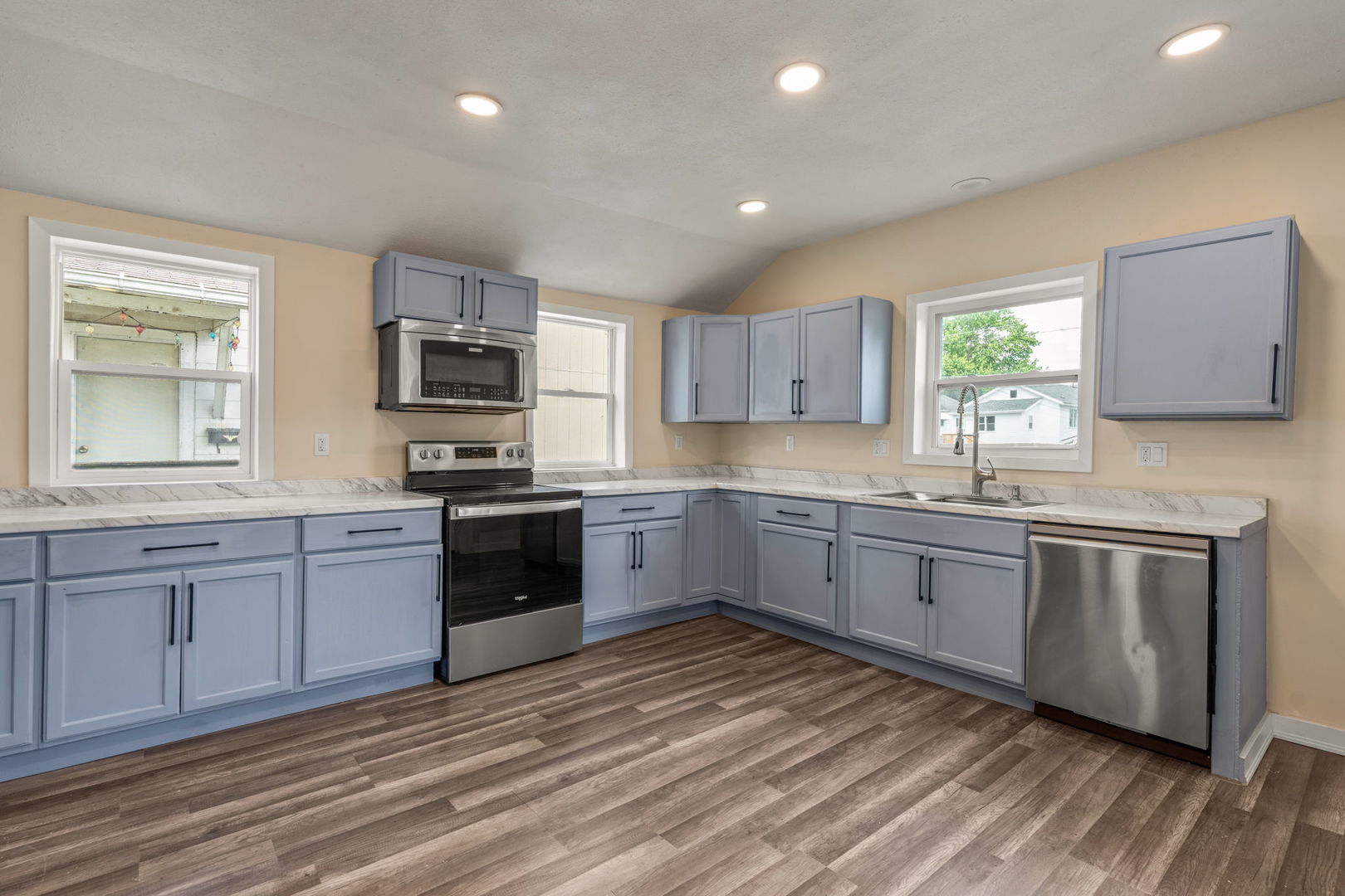 548 7th Avenue South Clinton, IA 52732 - Photo 10 of 23 a kitchen with granite countertop a stove top oven sink and cabinets