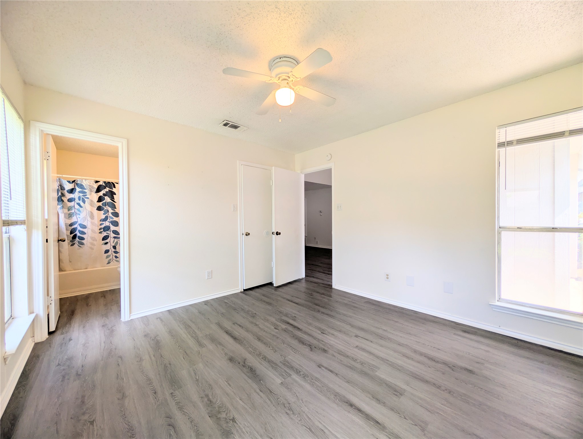 2036 Redwing Way Round Rock, TX 78664 - Photo 15 of 23 Primary Bedroom
Well-lit living area featuring contemporary flooring and a convenient ceiling fan for comfort.