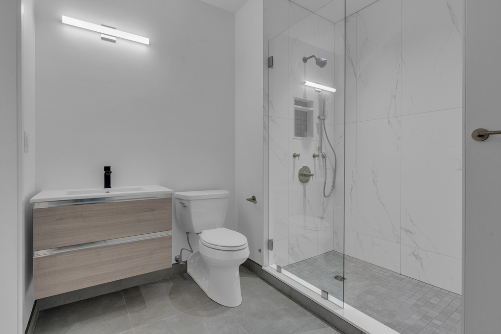 70-72 Northampton Street, Unit 502 Boston, MA 02118 - Photo 15 of 19 a bathroom with a shower a toilet and a sink