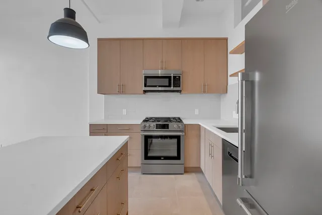 a kitchen with granite countertop a stove and a sink