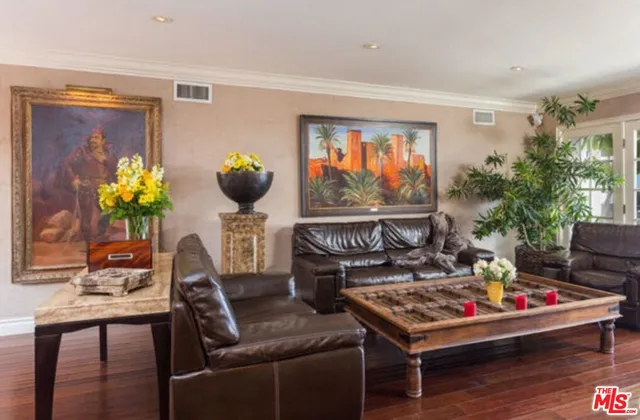 a dining room with furniture a chandelier and wooden floor