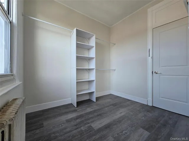 a view of walk in closet with empty racks