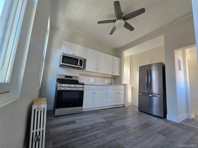 a kitchen with stainless steel appliances granite countertop a refrigerator stove and a sink