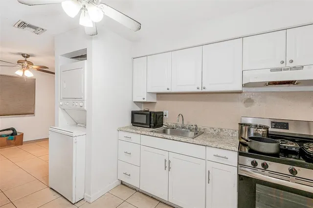 a kitchen with appliances cabinets and a sink