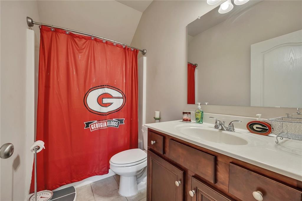 6204 Oakdale Ridge Court Southeast Mableton, GA 30126 - Photo 16 of 48 a bathroom with a sink a toilet and mirror
