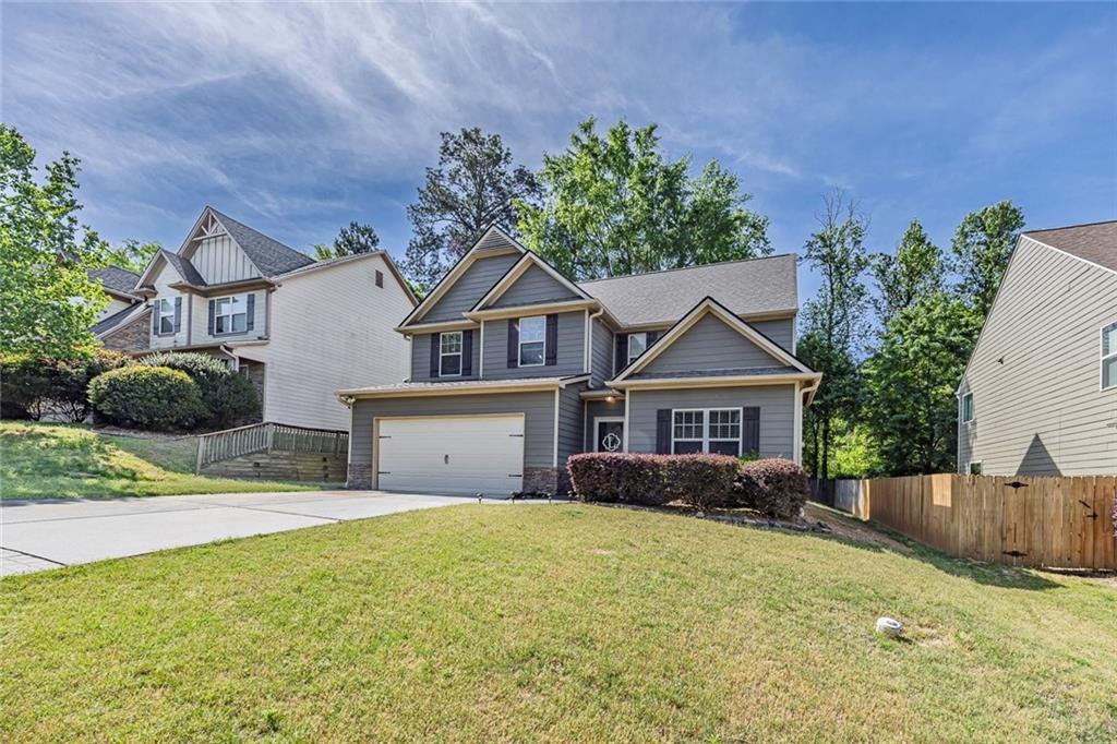 6204 Oakdale Ridge Court Southeast Mableton, GA 30126 - Photo 2 of 48 a front view of a house with a garden and yard