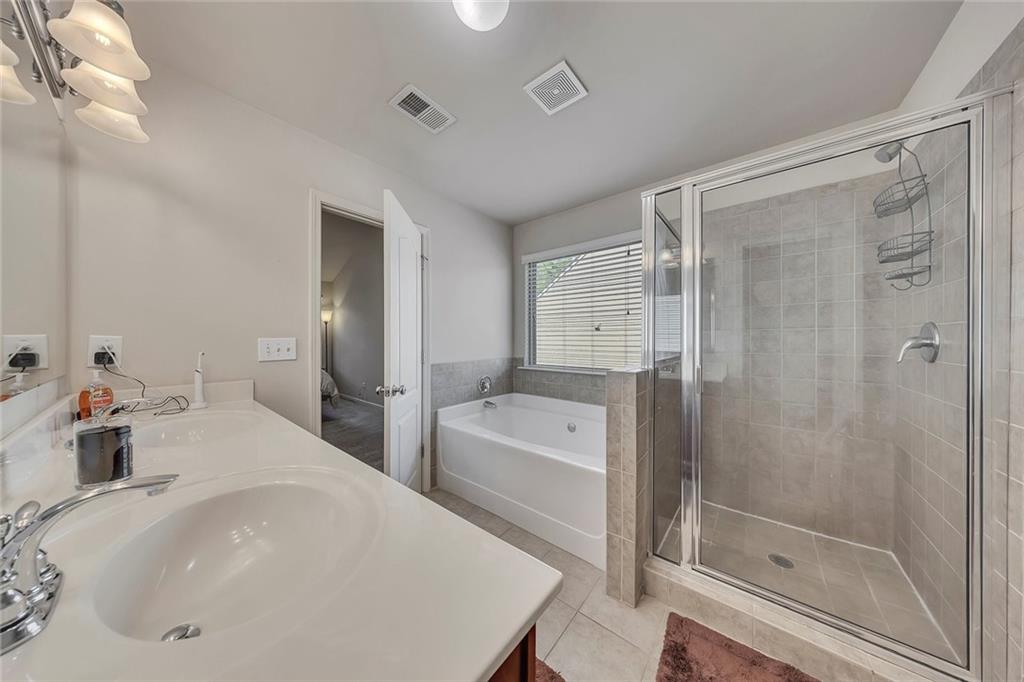 6204 Oakdale Ridge Court Southeast Mableton, GA 30126 - Photo 21 of 48 a en suite bathroom with a sink a mirror and a bathtub
