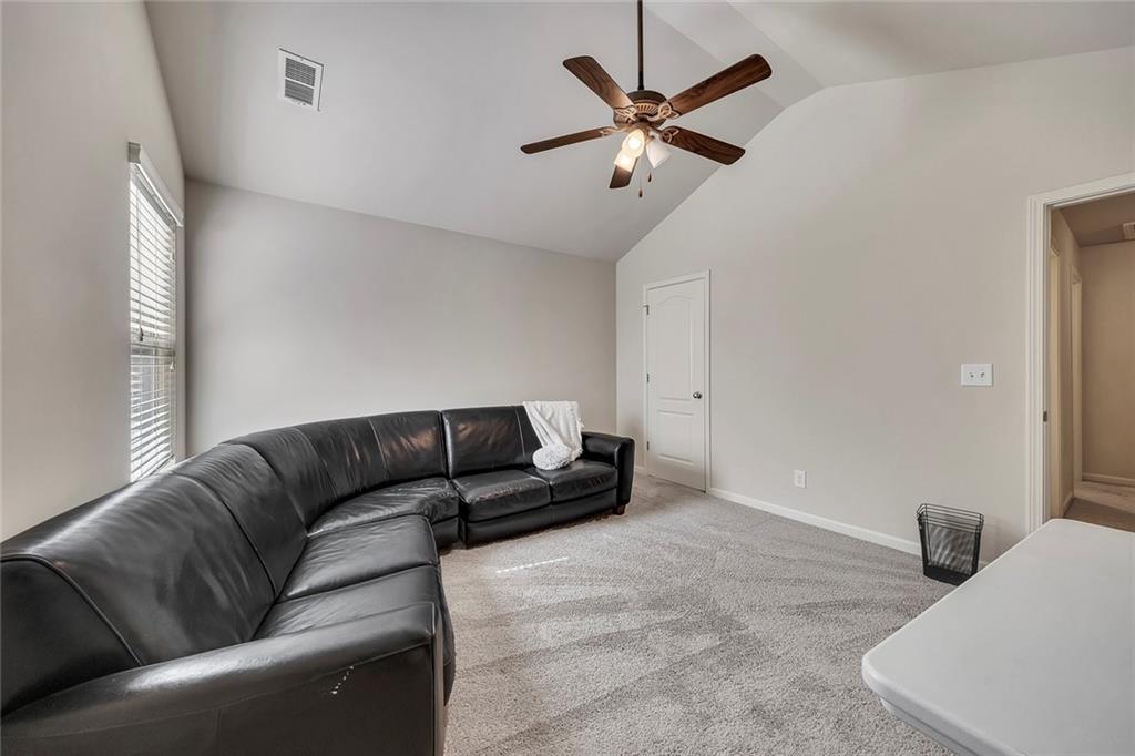 6204 Oakdale Ridge Court Southeast Mableton, GA 30126 - Photo 25 of 48 a living room with furniture and a ceiling fan