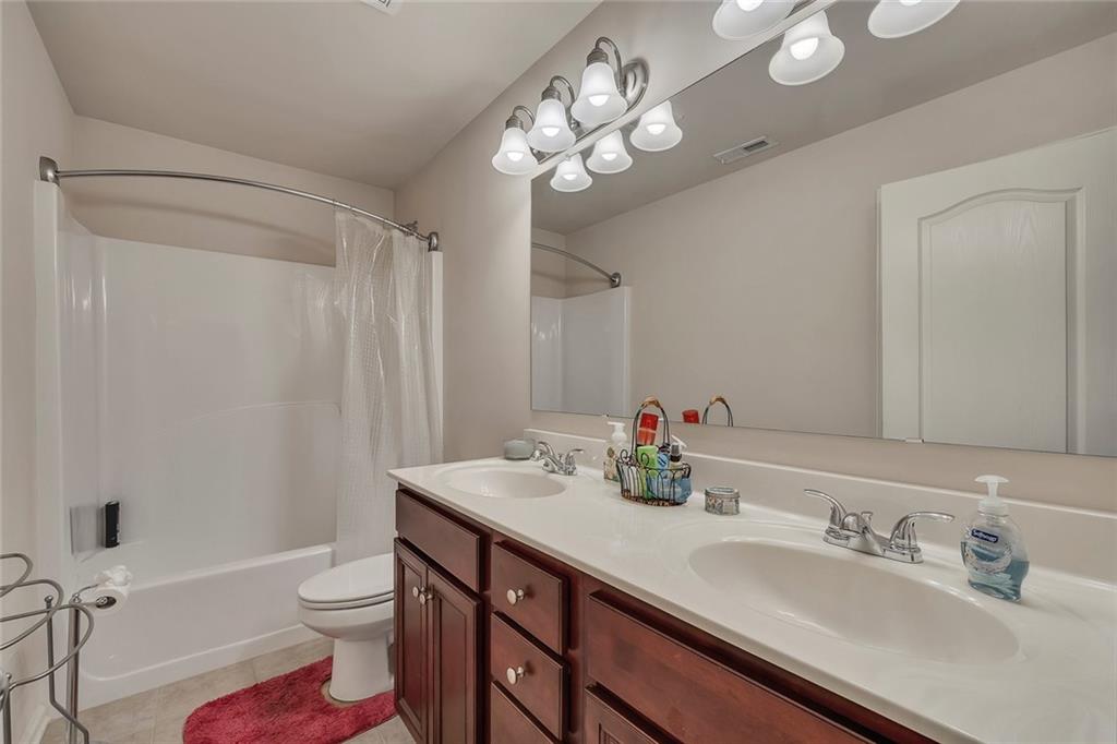 6204 Oakdale Ridge Court Southeast Mableton, GA 30126 - Photo 26 of 48 a bathroom with a sink a toilet a mirror a vanity and shower