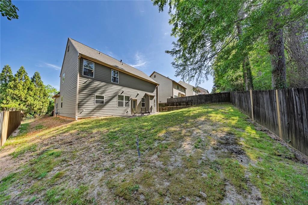 6204 Oakdale Ridge Court Southeast Mableton, GA 30126 - Photo 30 of 48 a view of a house with a yard and a bench