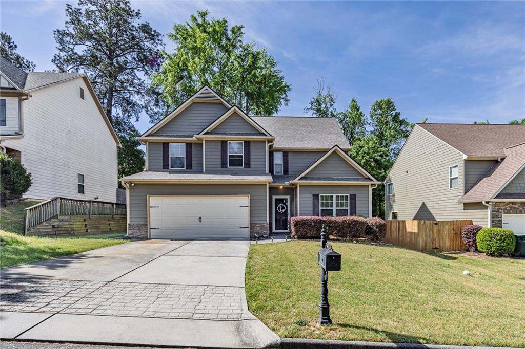 6204 Oakdale Ridge Court Southeast Mableton, GA 30126 - Photo 33 of 48 a front view of a house with garden