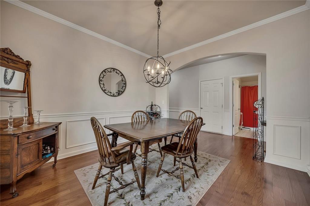 6204 Oakdale Ridge Court Southeast Mableton, GA 30126 - Photo 6 of 48 a view of a dining room with furniture wooden floor and a chandelier