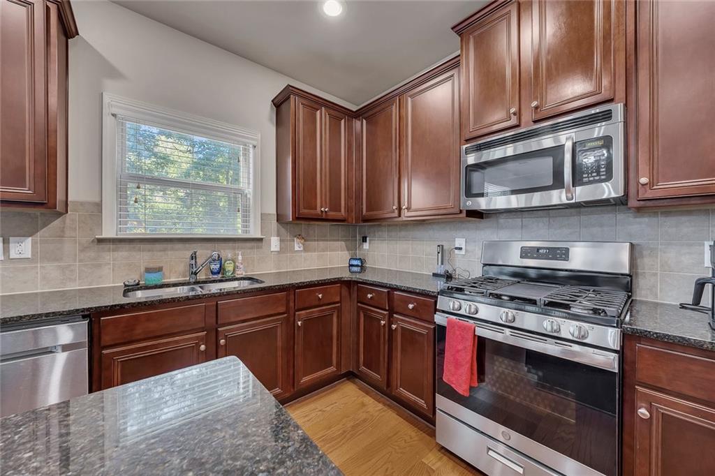 6204 Oakdale Ridge Court Southeast Mableton, GA 30126 - Photo 8 of 48 a kitchen with stainless steel appliances granite countertop a stove a sink dishwasher and a microwave oven with cabinets