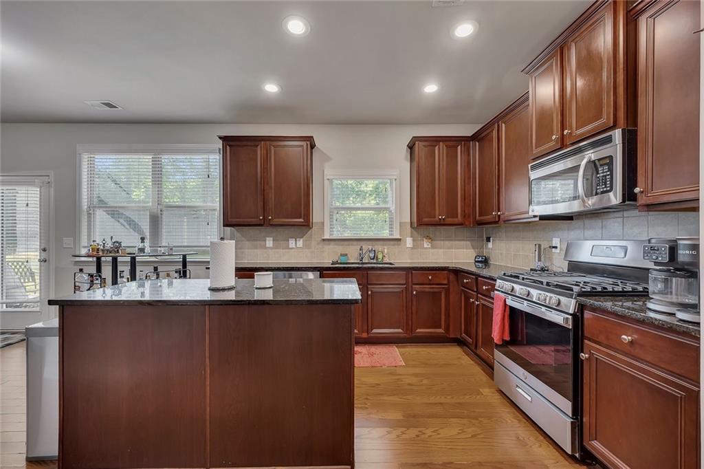 6204 Oakdale Ridge Court Southeast Mableton, GA 30126 - Photo 9 of 48 a kitchen with stainless steel appliances granite countertop a sink stove microwave and refrigerator