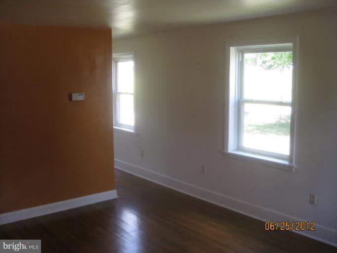 4810 Greencrest Road Baltimore, MD 21206 - Photo 4 of 14 an empty room with wooden floor and windows
