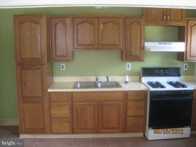4810 Greencrest Road Baltimore, MD 21206 - Photo 6 of 14 a kitchen with stainless steel appliances granite countertop a sink and a cabinets