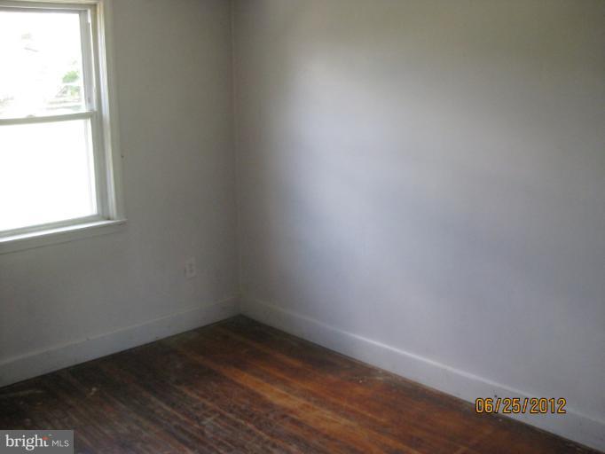 4810 Greencrest Road Baltimore, MD 21206 - Photo 10 of 14 a view of a small space with wooden floor and a window