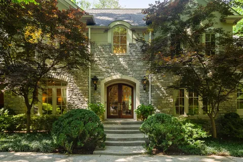 a front view of a house with garden