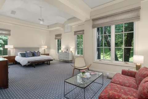 a spacious bedroom with a bed and a couch