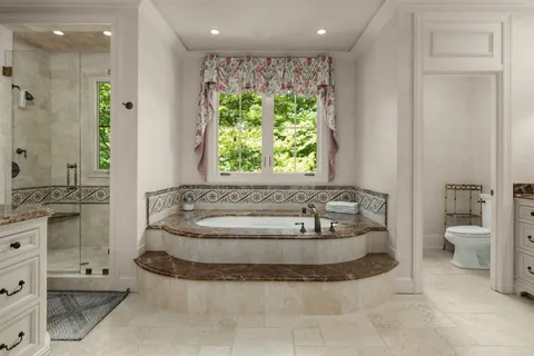 a bathroom with a granite countertop sink double vanity and a mirror