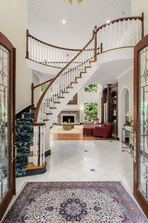 a living room with stairs and a rug