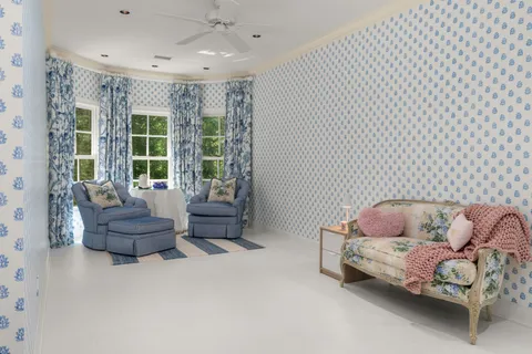 a living room with furniture and a potted plant