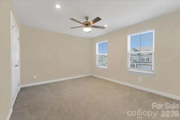 a view of a livingroom with a ceiling fan and window