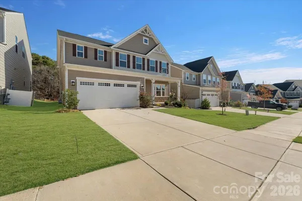 a front view of a house with a yard and garage