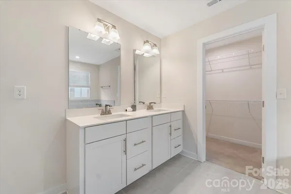 a bathroom with a double vanity sink mirror and double